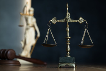 Law and Justice, judge gavel with scales on wooden table.