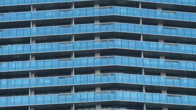 Closeup Glass Facade of Modern Luxury Condominiums and Balconies of Tall Skyscraper