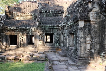 Empty windows of a dilapidated temple. Medieval ruins in Indochina.