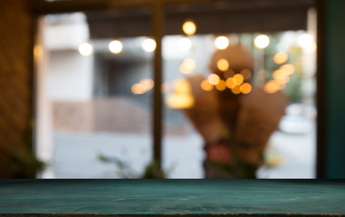 Empty wood table top on blur light gold bokeh of cafe restaurant in dark background