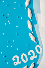 Paper flat lay in blue and white with marshmallow mice and paper number 2020