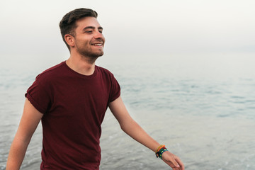 Fototapeta premium Cheerful man walking along seaside