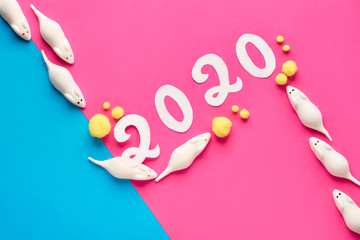 Festive diagonal paper background for New Year 2020 with mice in pink and blue