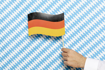 Man holding german flag with patterned background