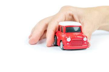 Car insurance. Car miniature covered by hands.