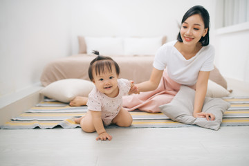 asian mother and child relaxing on the bed room