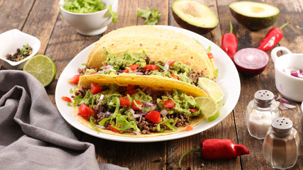 mexican meal, fajitas with minced beef, tomato, salad, onion and avocado