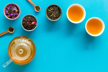 Tea ceremony frame with leaves and brew on blue background top view copyspace