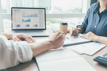 Asian advertising designer creative start-up team discussing ideas in office.