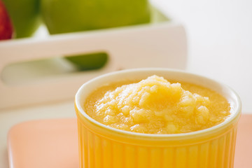 Homemade healthy baby food. Bowl of apple baby puree.