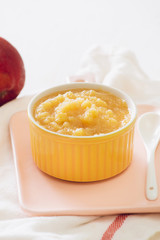 Homemade healthy baby food. Bowl of apple baby puree.