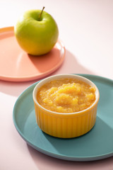 Natural baby food concept. Bowl of apple baby puree.