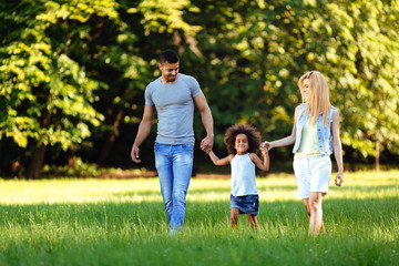 Obraz premium Happy young couple spending time with their daughter