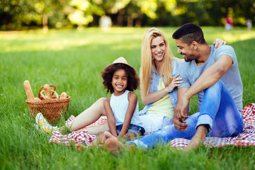 Picture of lovely couple with their daughter having picnic