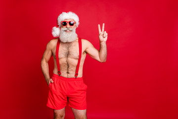 Fototapeta na wymiar Portrait of his he nice attractive content cheerful cheery funky optimistic gray-haired muscular macho showing v-sign enjoying leisure rest relax isolated over bright vivid shine red background