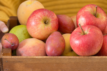 Wooden box with fruit in his hands. Healthy diet