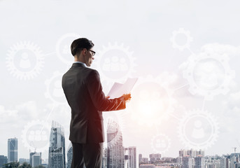 Concept of business success and control with confident boss against cityscape background