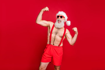 Portrait of his he nice attractive content powerful bearded gray-haired man crossfit trainer instructor bodybuilder showing biceps triceps fit acre isolated over bright vivid shine red background