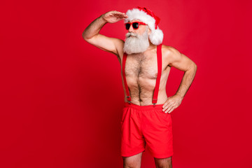 Portrait of his he nice attractive content serious focused attentive gray-haired man St Saint Nicholas looking far away wintertime isolated over bright vivid shine red background