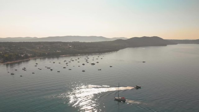a professional looking aerial, flying right over some moving boats at the adriatic sea, croatia
