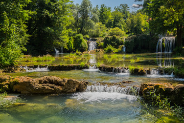 Fototapeta na wymiar Scenic waterfall cascades on the river Sluncica. Magnificent Southern Europe, Croatia, small town Slunj. Beautiful day. The concept of ecological, active and photo tourism