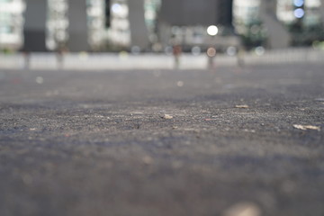 Close up Asphalt ground at car parking area with bokeh behind.