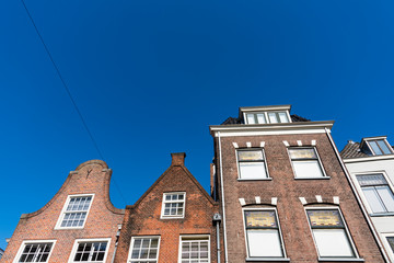 Fototapeta na wymiar Apartments and houses in street called Oude Langendyk. In Delft, The Netherlands