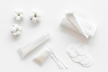 Cotton pads, swabs and cream for blog design on white background top view