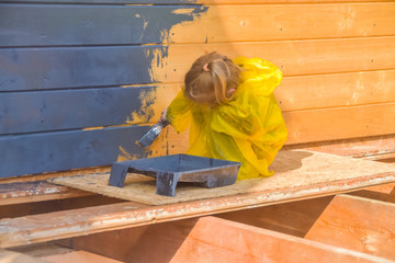 child paints a house brush out