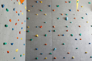 Walls with climbing holds in gym