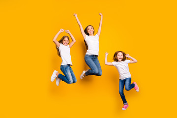 Fototapeta na wymiar Full body photo of three ladies jumping high spending weekend wear casual clothes isolated yellow background