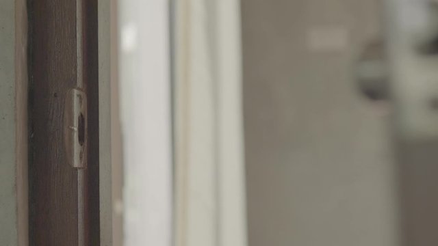Men's hand open the door home close up. Slog3
