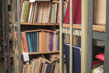 Blurred image of old books on bookshelves in the library