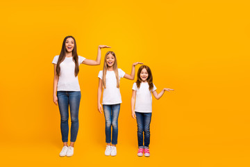 Full size photo of three sister ladies not believe such quick growing up wear casual outfit isolated yellow background - obrazy, fototapety, plakaty