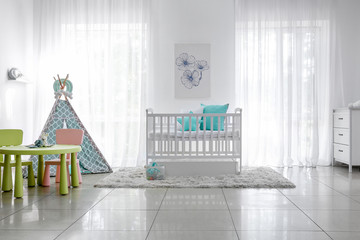 Interior of stylish children's room with baby bed