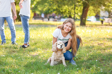 Naklejka na ściany i meble Female volunteer with cute dog outdoors