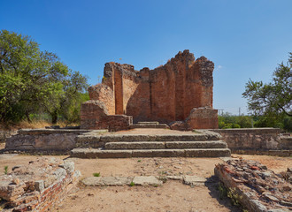 Fototapeta premium Looking up the steps towards the Water Temple at the Roman ruins of Milreu in the town of Estoi on the Algarve of Portugal.