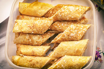 Stuffed pancakes in a food container. Delicious pancake breakfast