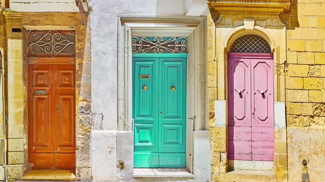 Compilation of vintage wooden doors with carved details and different knob knockers or door handles, found in towns and villages of Malta and Gozo Islands