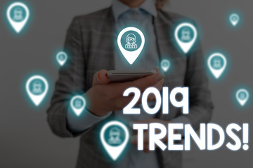 Handwriting text writing 2019 Trends. Conceptual photo general direction in which something is developing or changing Woman wear formal work suit presenting presentation using smart device