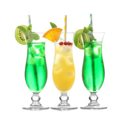 Glasses of cold cocktails on color background