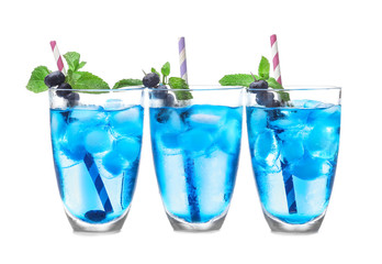 Glasses of cold cocktails on color background