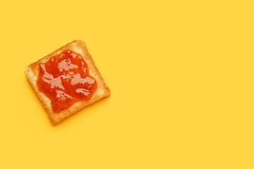 Tasty toasted bread with jam on color background