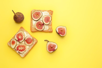Tasty toasted bread with fig fruit on color background