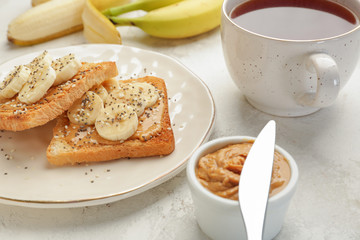 Plate with tasty sandwiches on table