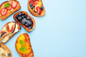 Different tasty sandwiches on color background