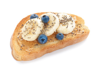 Tasty toasted bread with fruits and peanut butter on white background