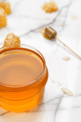 Jar of sweet honey on table