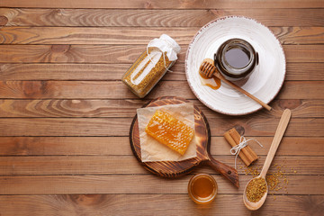 Composition with sweet honey on wooden table