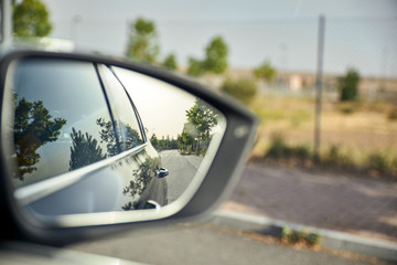 view of the exterior mirror of a car while driving